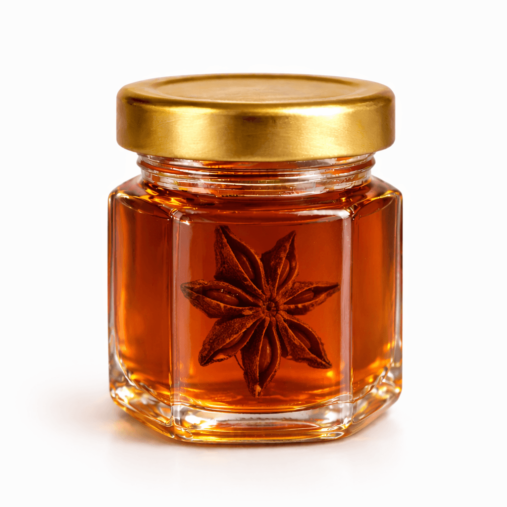 A jar of Dear Nature honey with a single whole star anise suspended inside